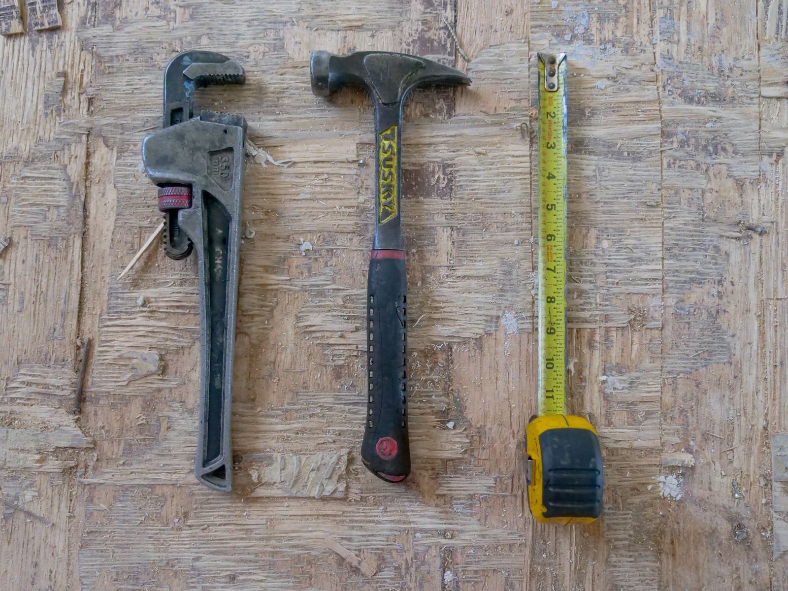 Professional plumbing hand tools arranged on a work surface