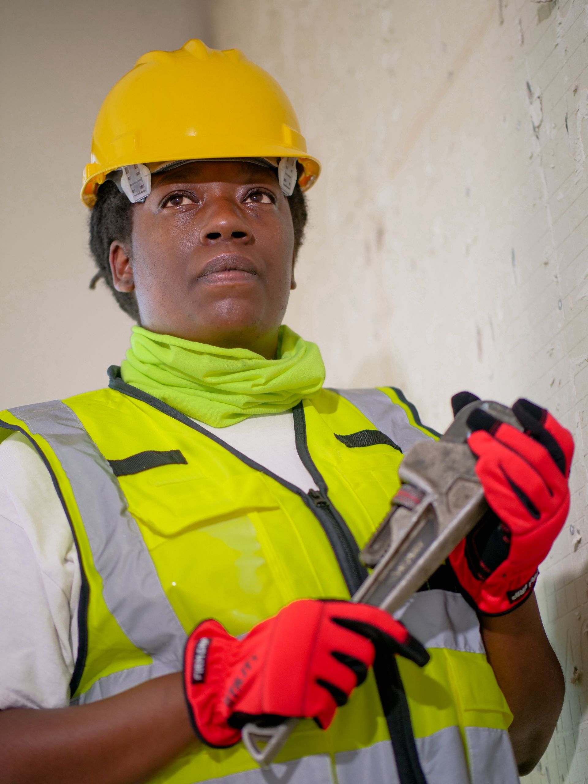 Professional plumber holding a wrench on the job