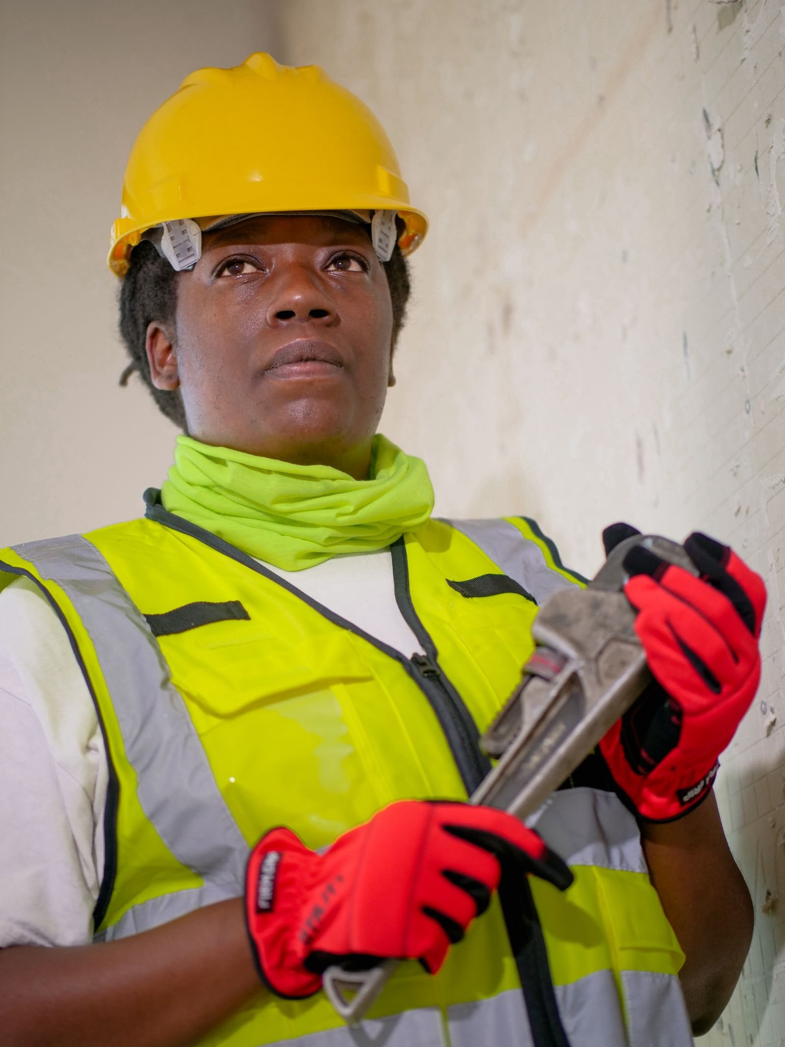 Smiling plumbing professional holding a wrench