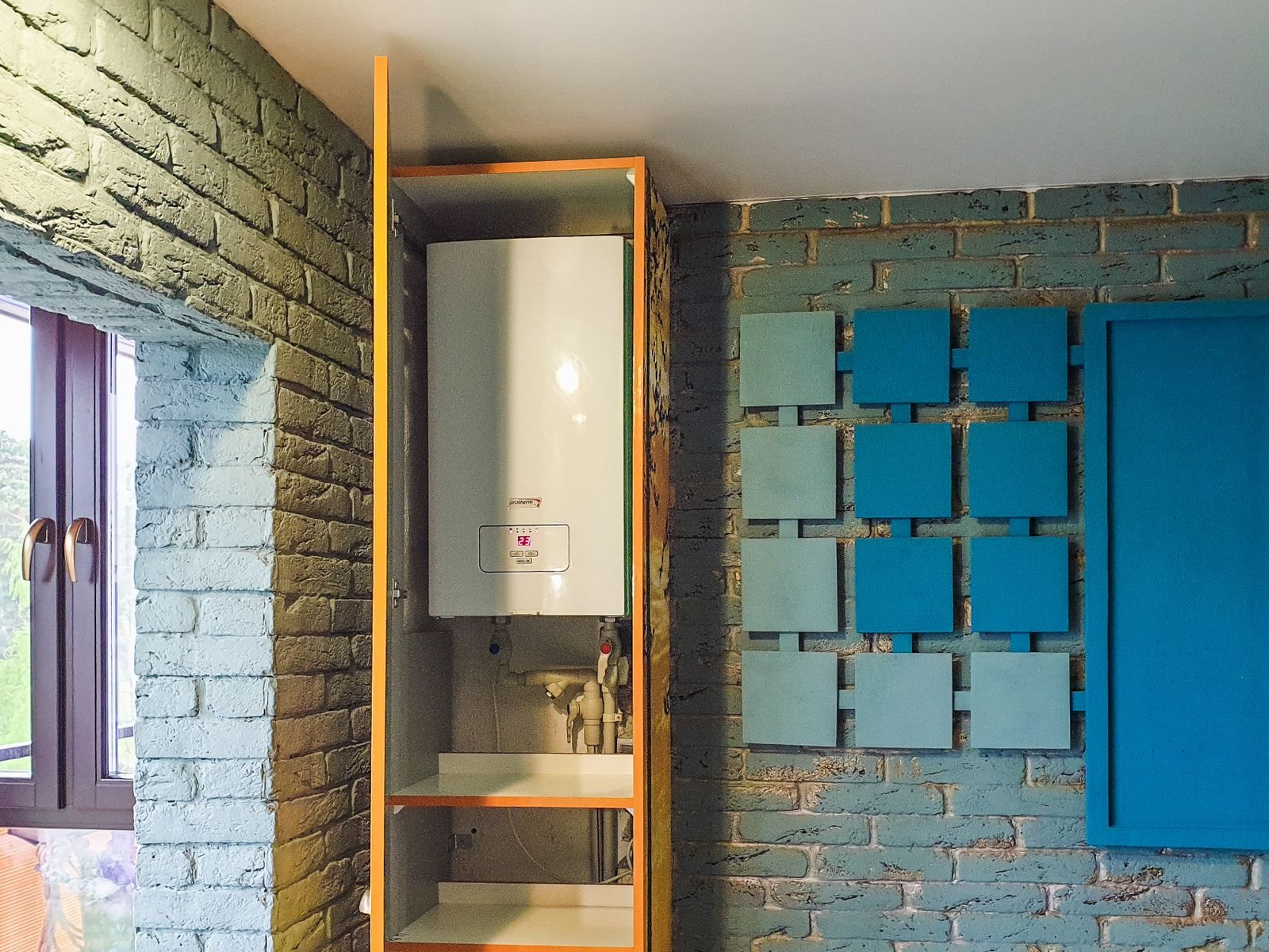 Wall-mounted high-efficiency water heating unit inside a utility cabinet